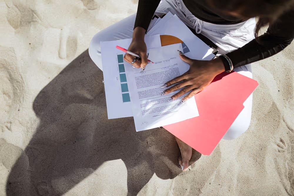 A diver signing a waiver on the beach