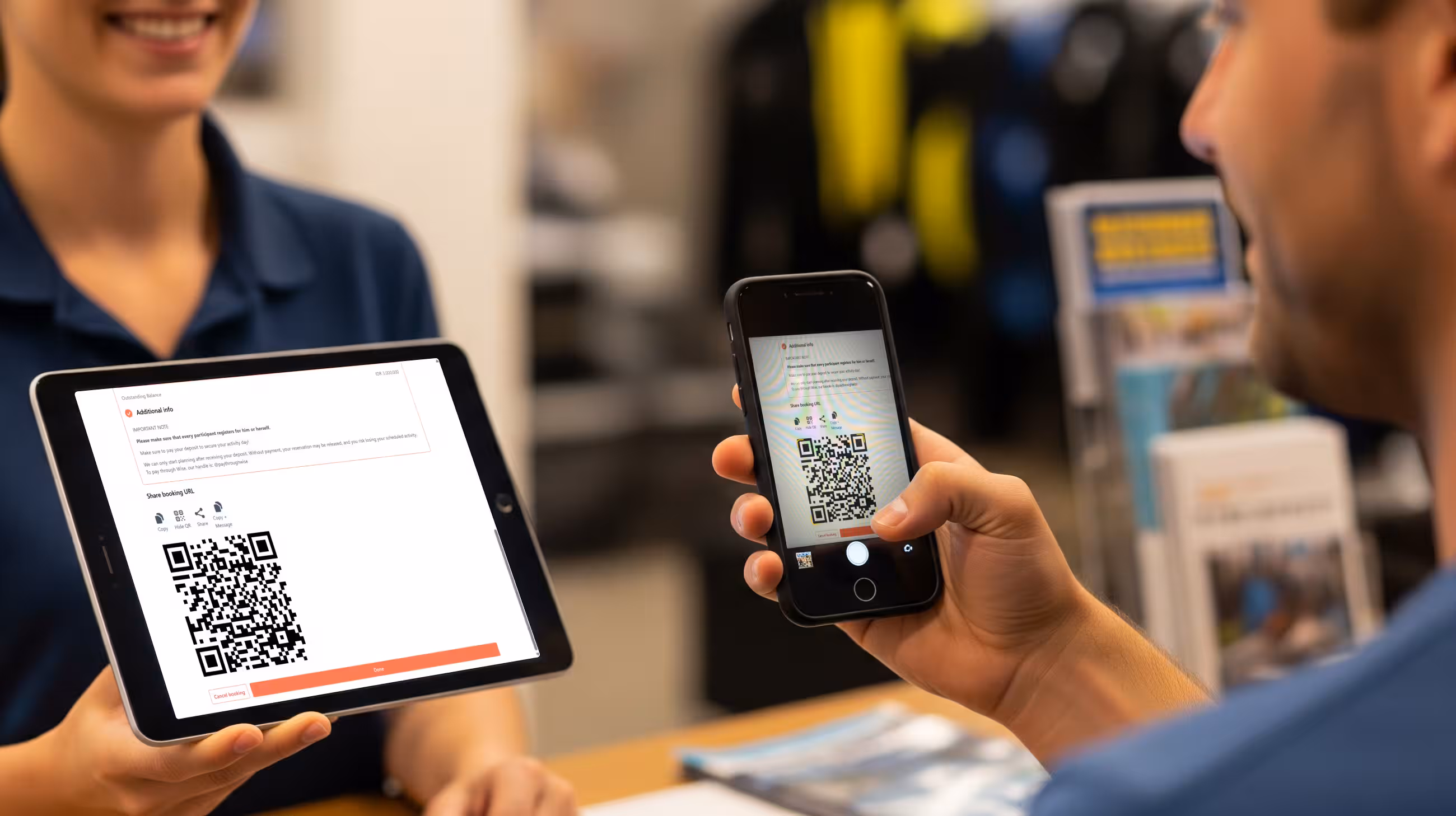 An image showing a customer scanning a QR code from the tablet of the dive shop staff member, representing a streamlined onboarding on the DiversDesk platform.
